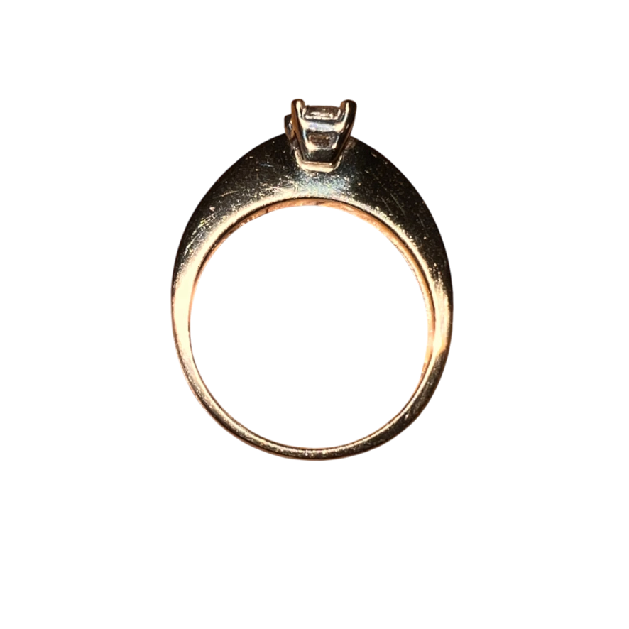 Gold ring with a diamond on a white background