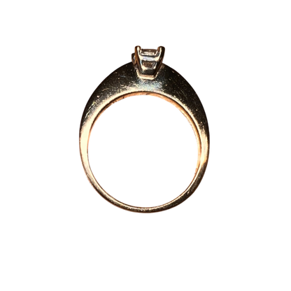 Gold ring with a diamond on a white background