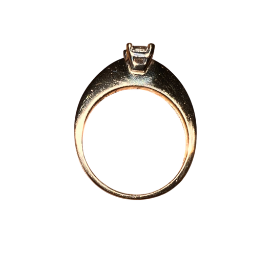 Gold ring with a diamond on a white background